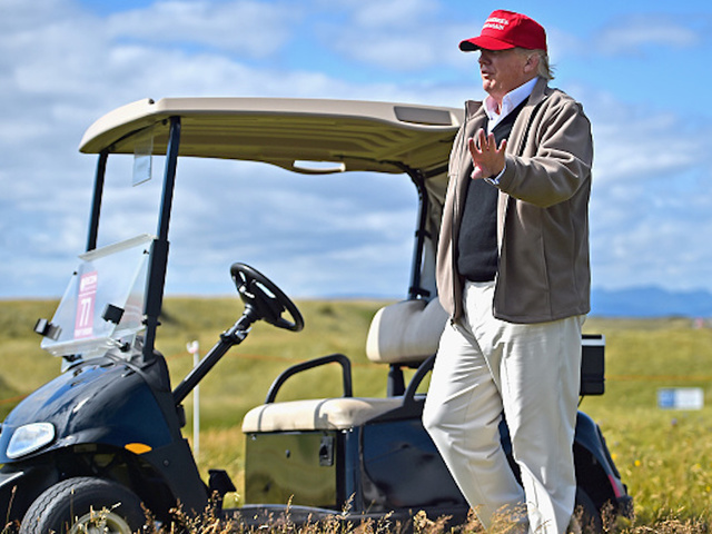 President Trump drives cart across putting green at New Jersey golf course
